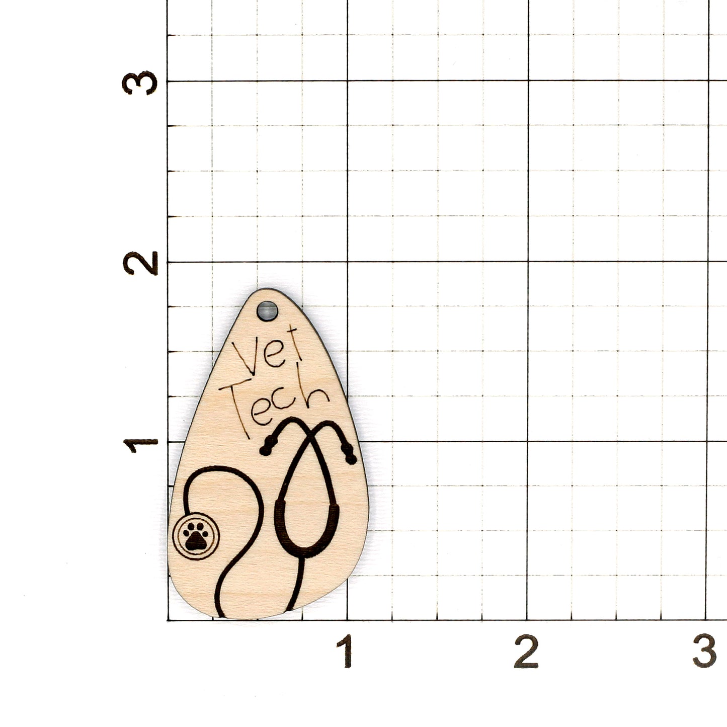 Wooden earring with 'Vet Tech' and stethoscope design on a grid background