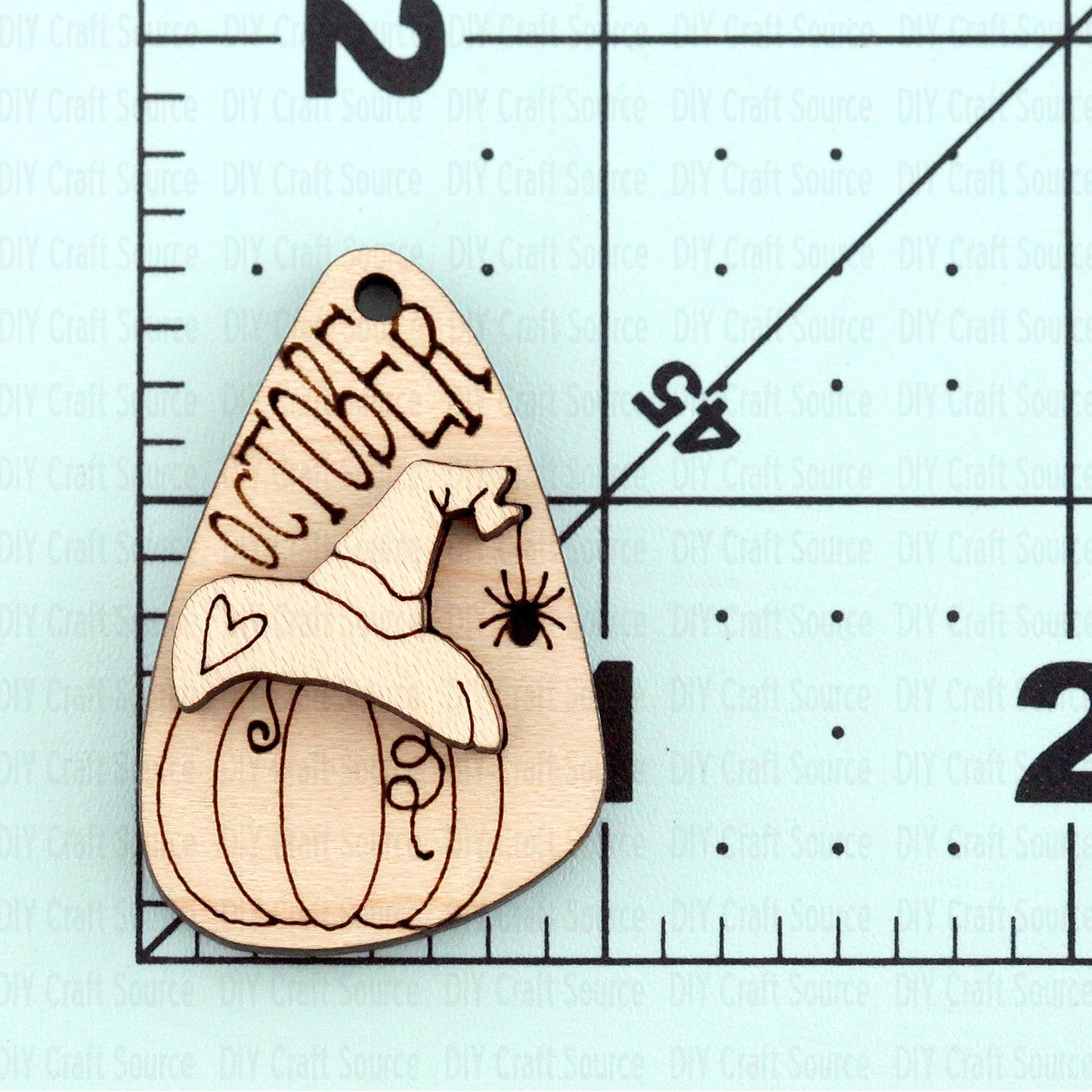 Wooden pumpkin-shaped laser blank with 'October' engraving is ready to paint for Halloween earrings