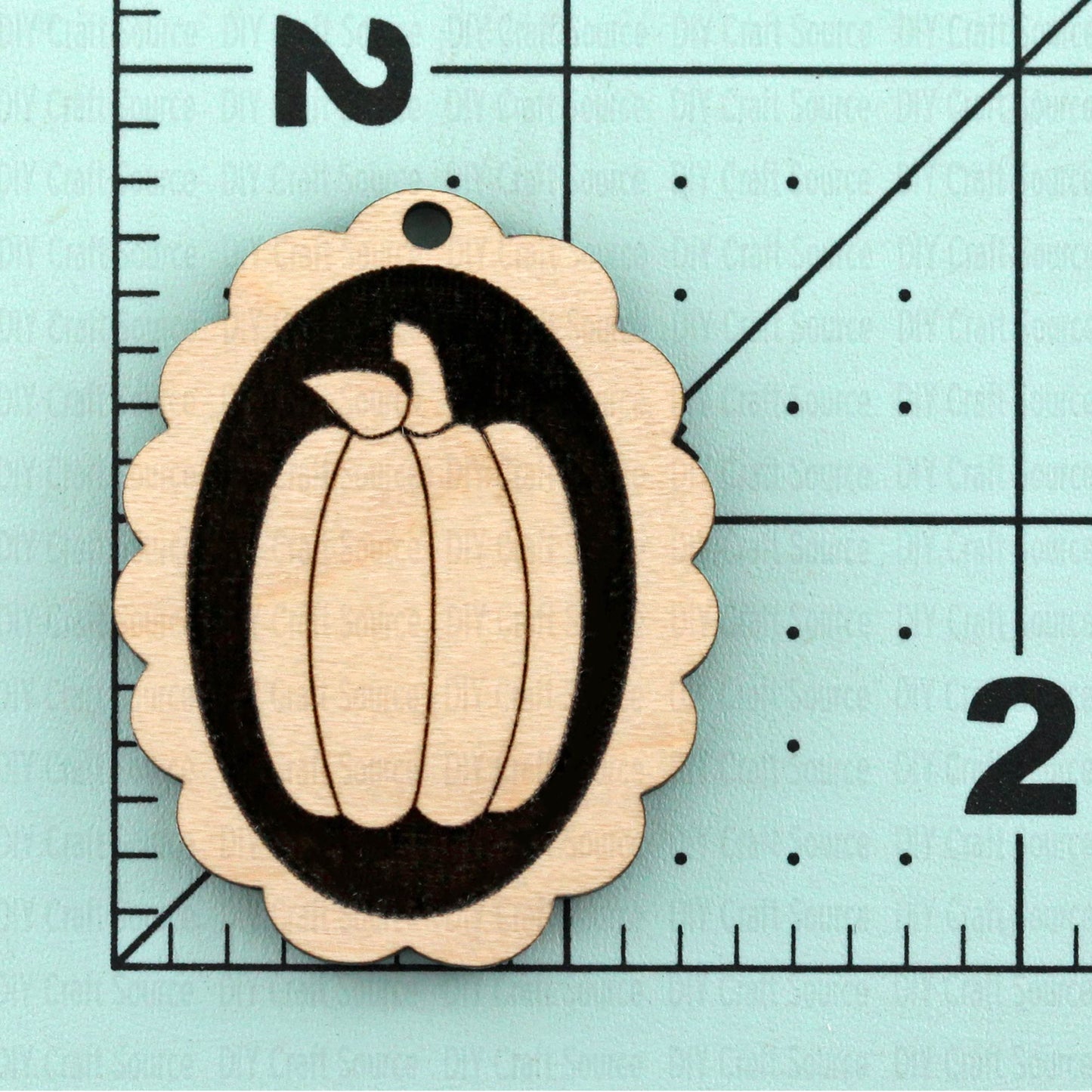 Wooden pumpkin-shaped cutout with black outline unfinished earring blank