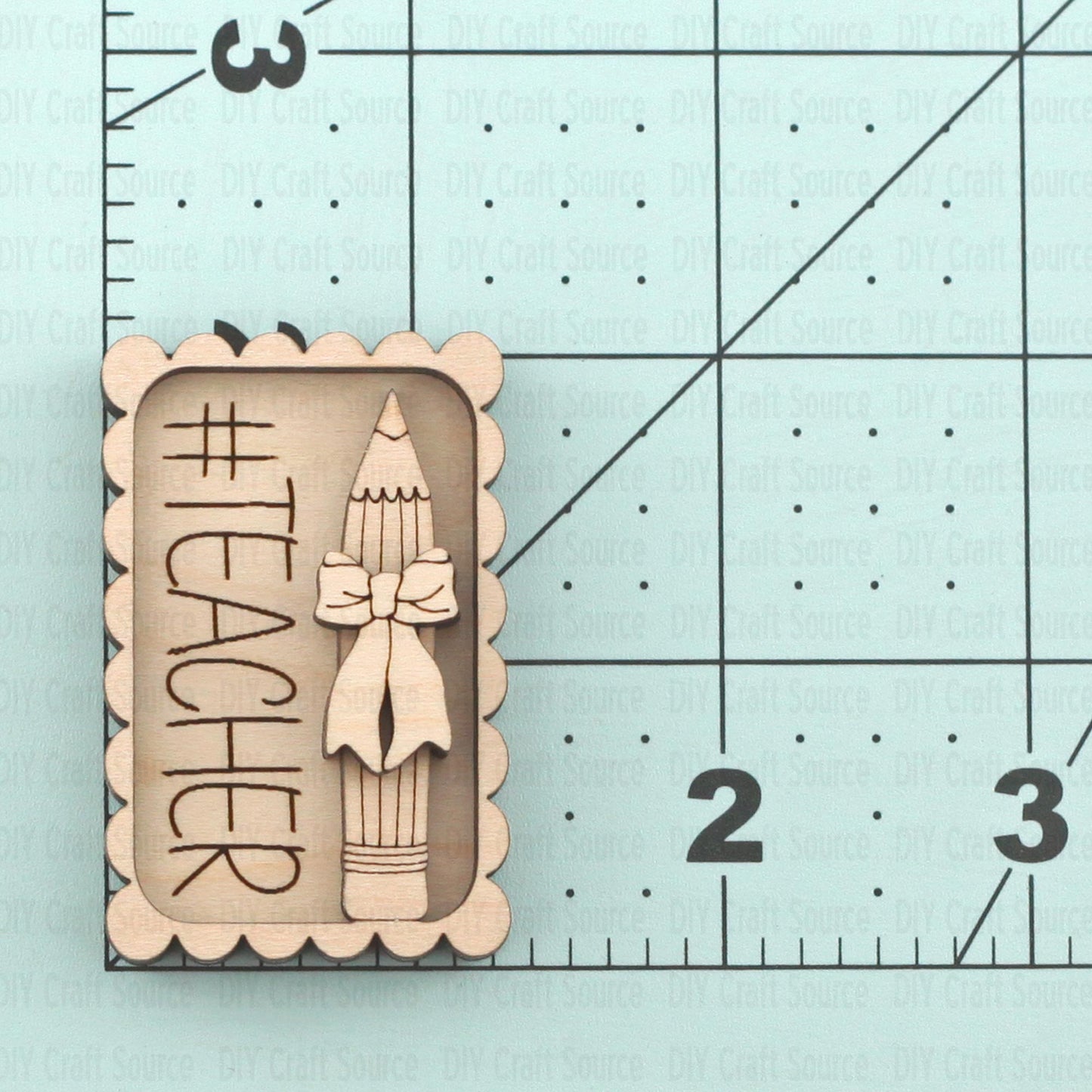 Wooden cutout of a pencil with a bow tie and 'Teacher' text on a laser wood blank for hair clip