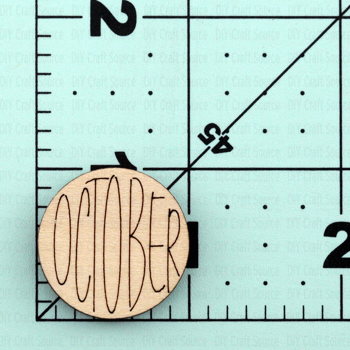 Wooden circle with 'OCTOBER' text on a laser blank