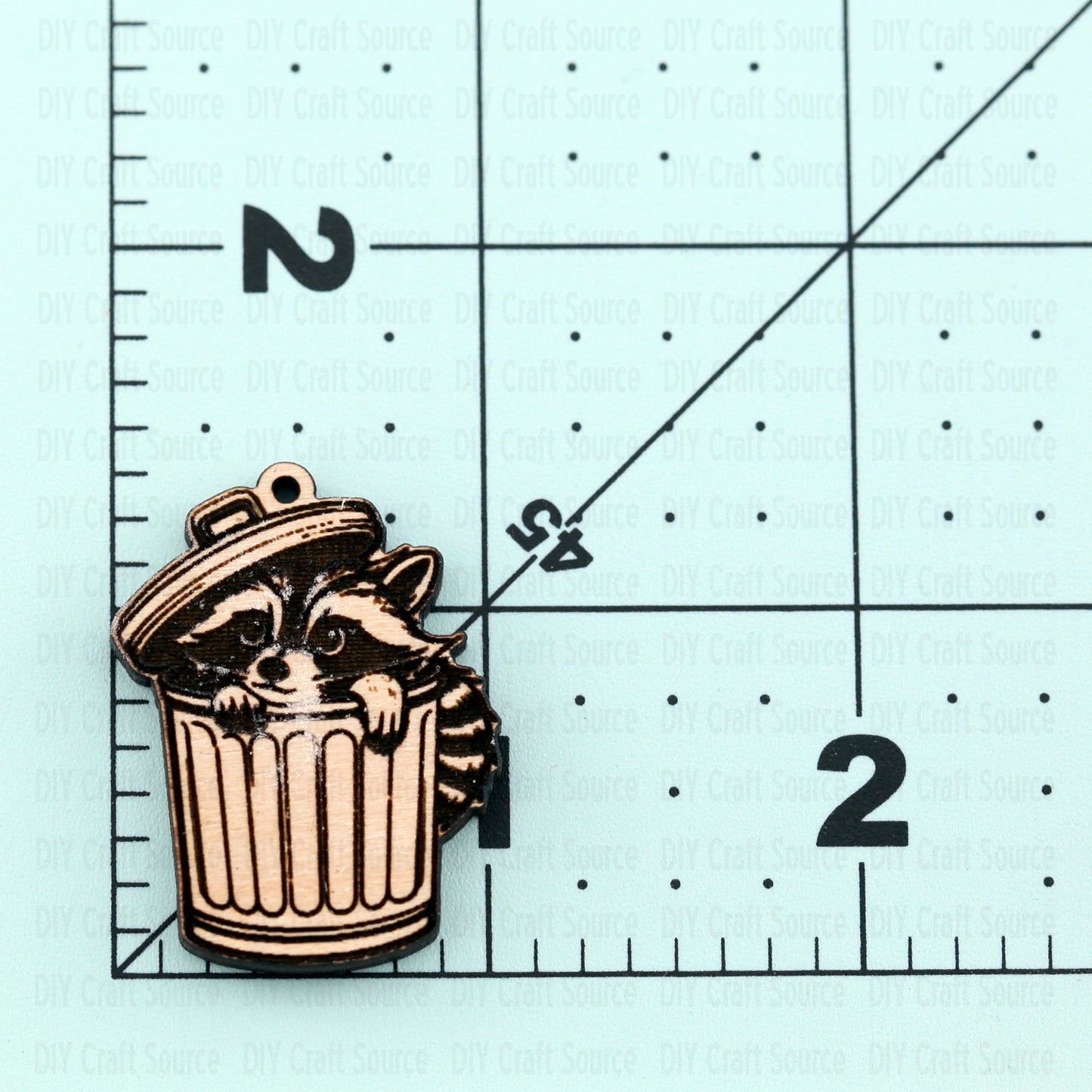 Unfinished laser blank earrings with racoon peeking out of a trash can, ready to be painted or stained.