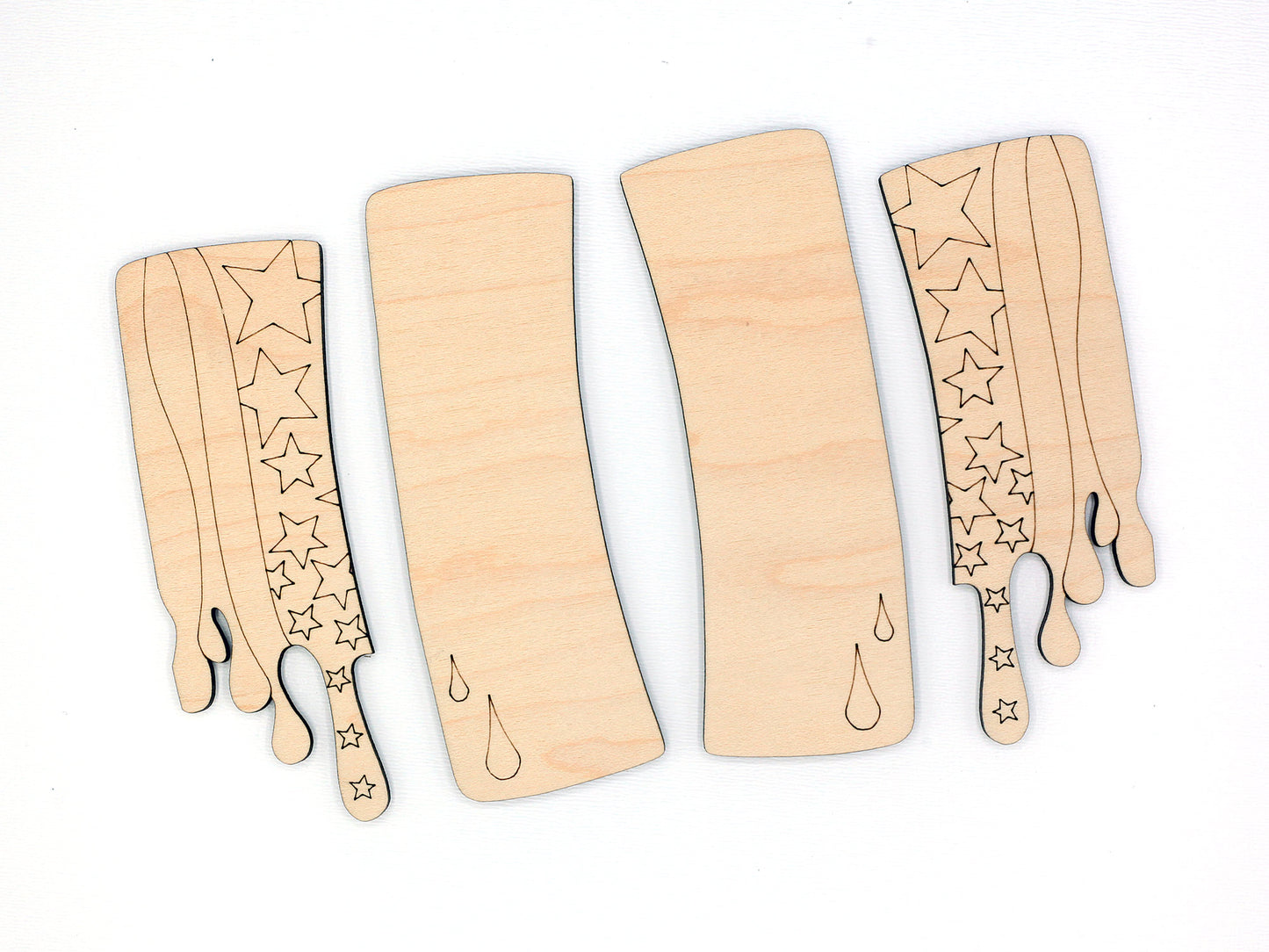 Wood claw clip blanks with star and stripe patterns on a white background