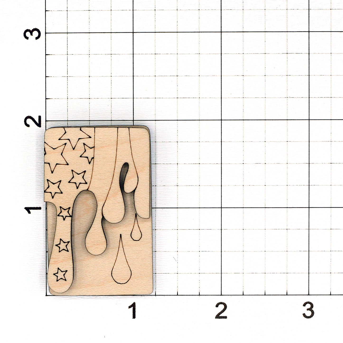 Wooden hair clip blank with flag pattern on a grid background