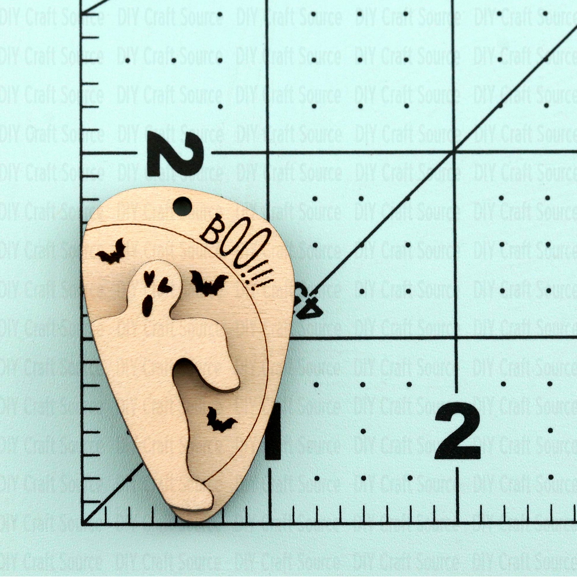 Wooden laser blank earrings of a ghost with bats and 'BOO!!!' that are ready to paint