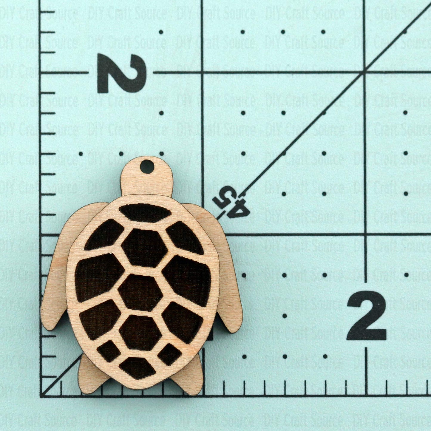 Wooden turtle-shaped earring that is ready to paint