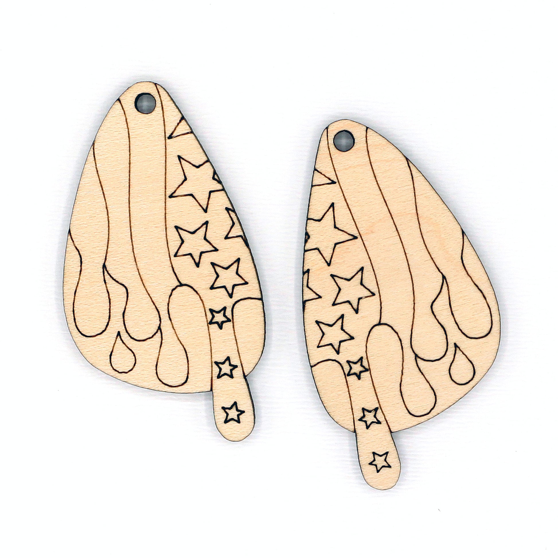 Two wooden earrings with star patterns on a white background