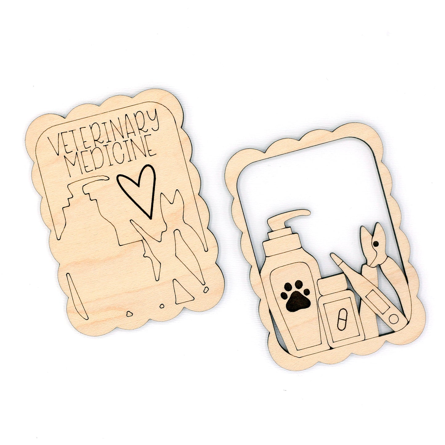 Two wooden cutouts with engraved designs of a heart, paw, and medical tools on a white background.