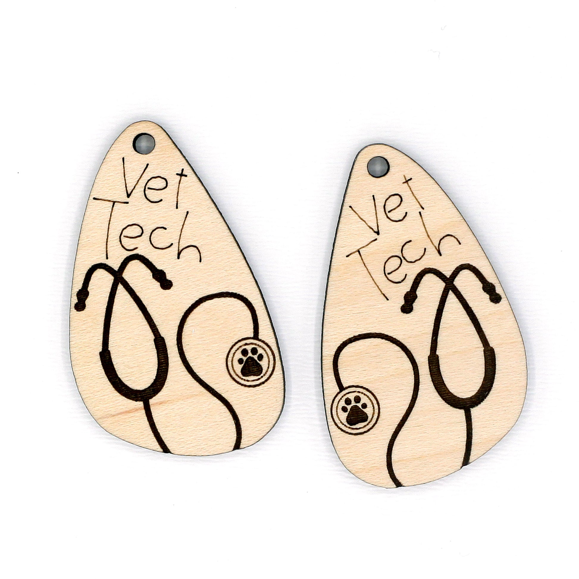 Two wooden earrings with 'Vet Tech' and stethoscope design on a white background