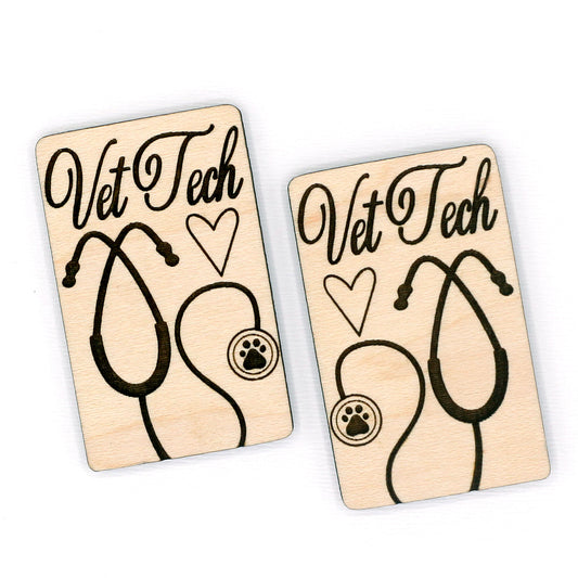 Two wooden hair clip pieces with 'Vet Tech' and stethoscope design on a white background