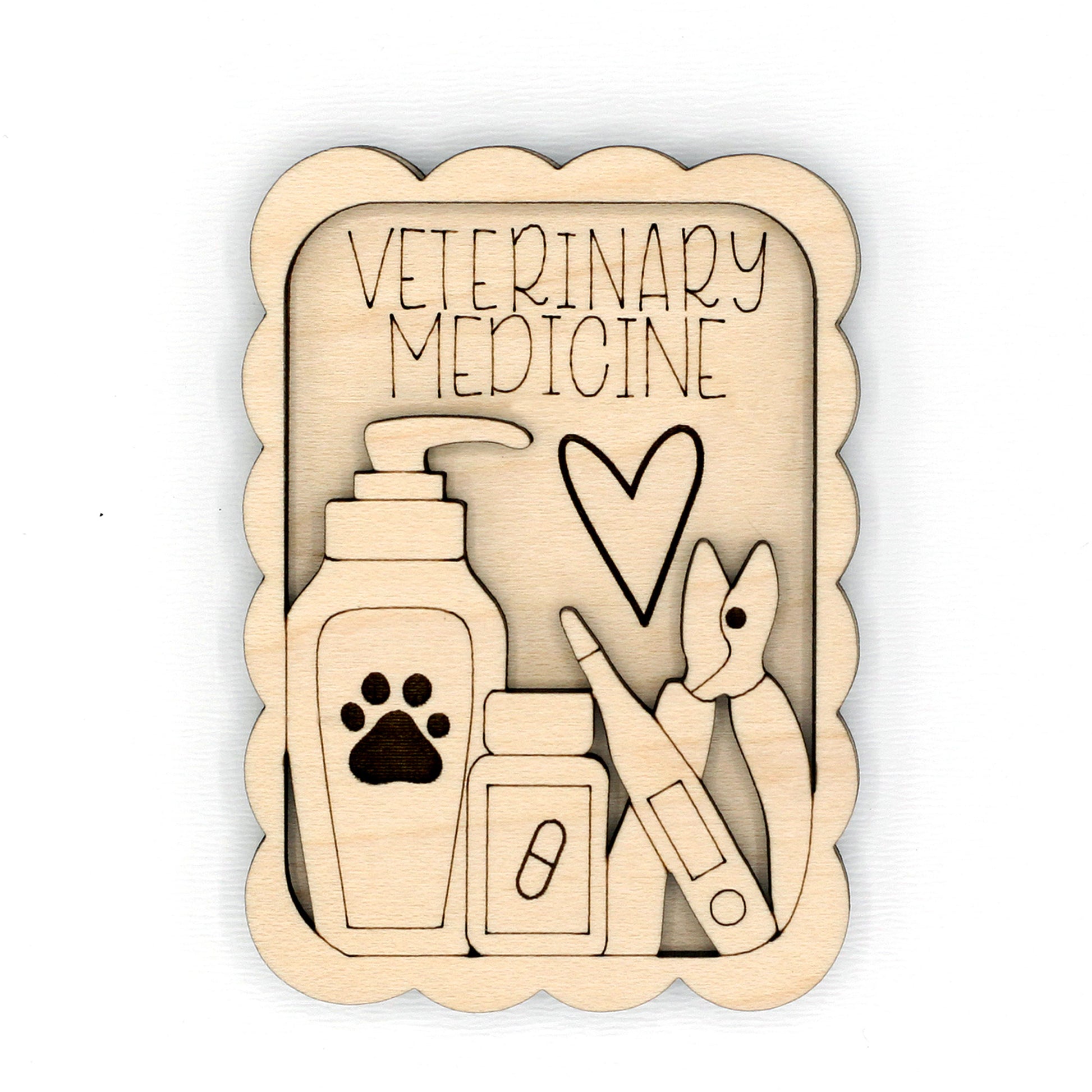 Wooden cutout with veterinary medicine theme including a heart, paw print, and medical tools on a white background.
