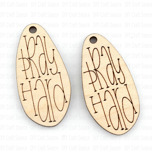 Two wooden laser blanks with 'Pray Hard' engraving that are ready to paint for earrings