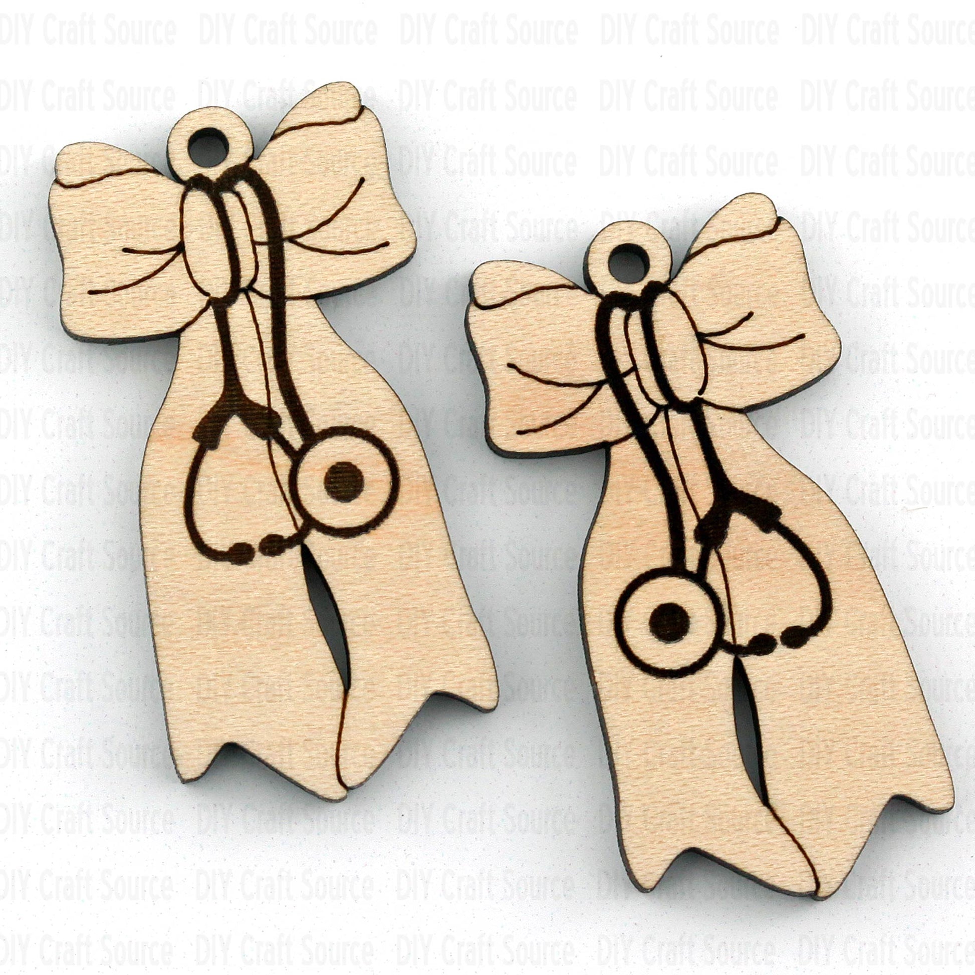 Two wooden earrings with bow designs and stethoscope symbol
