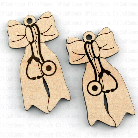 Two wooden earrings with bow designs and stethoscope symbol