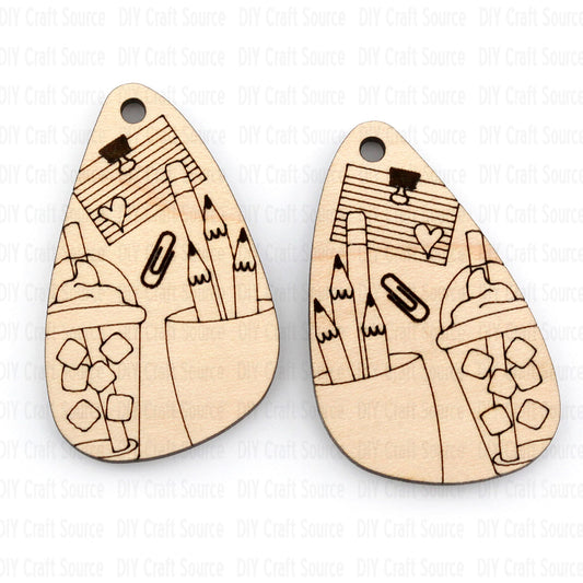 Wooden earrings with laser-cut teacher designs on a white background