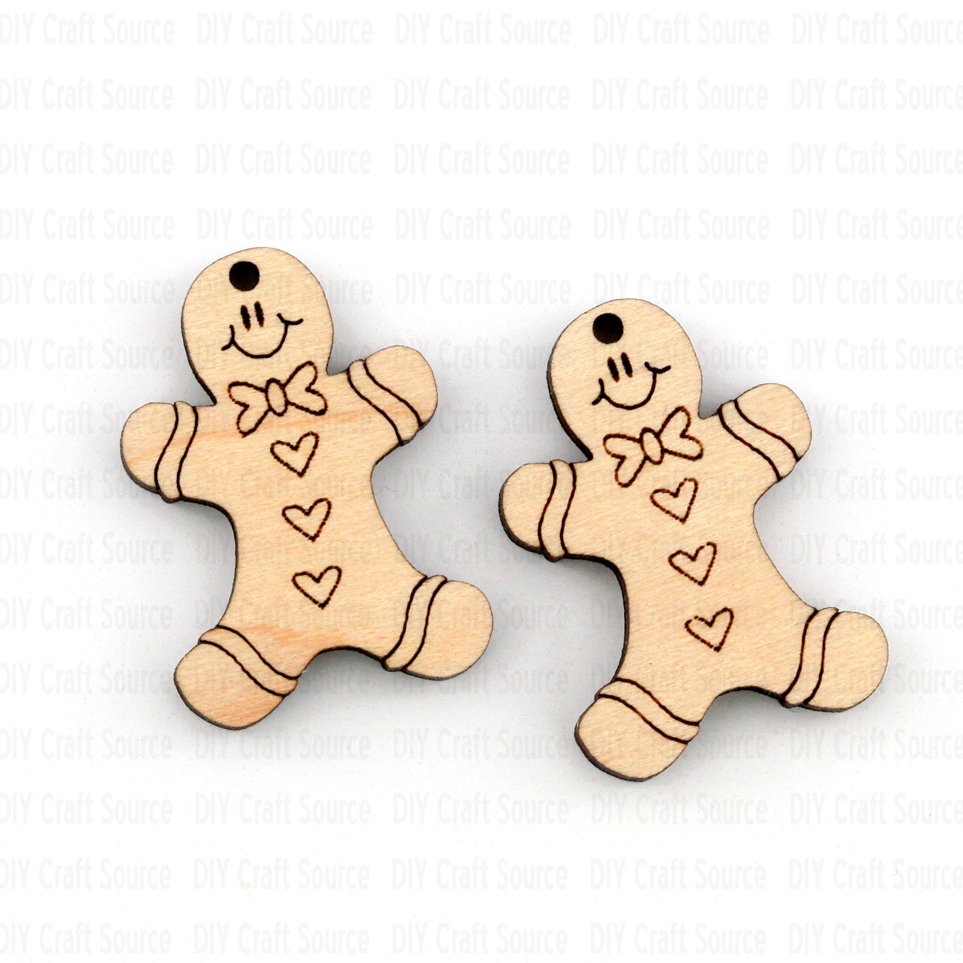 Two wooden gingerbread man earrings with smiley faces, hearts, and a bow tie on a white background.